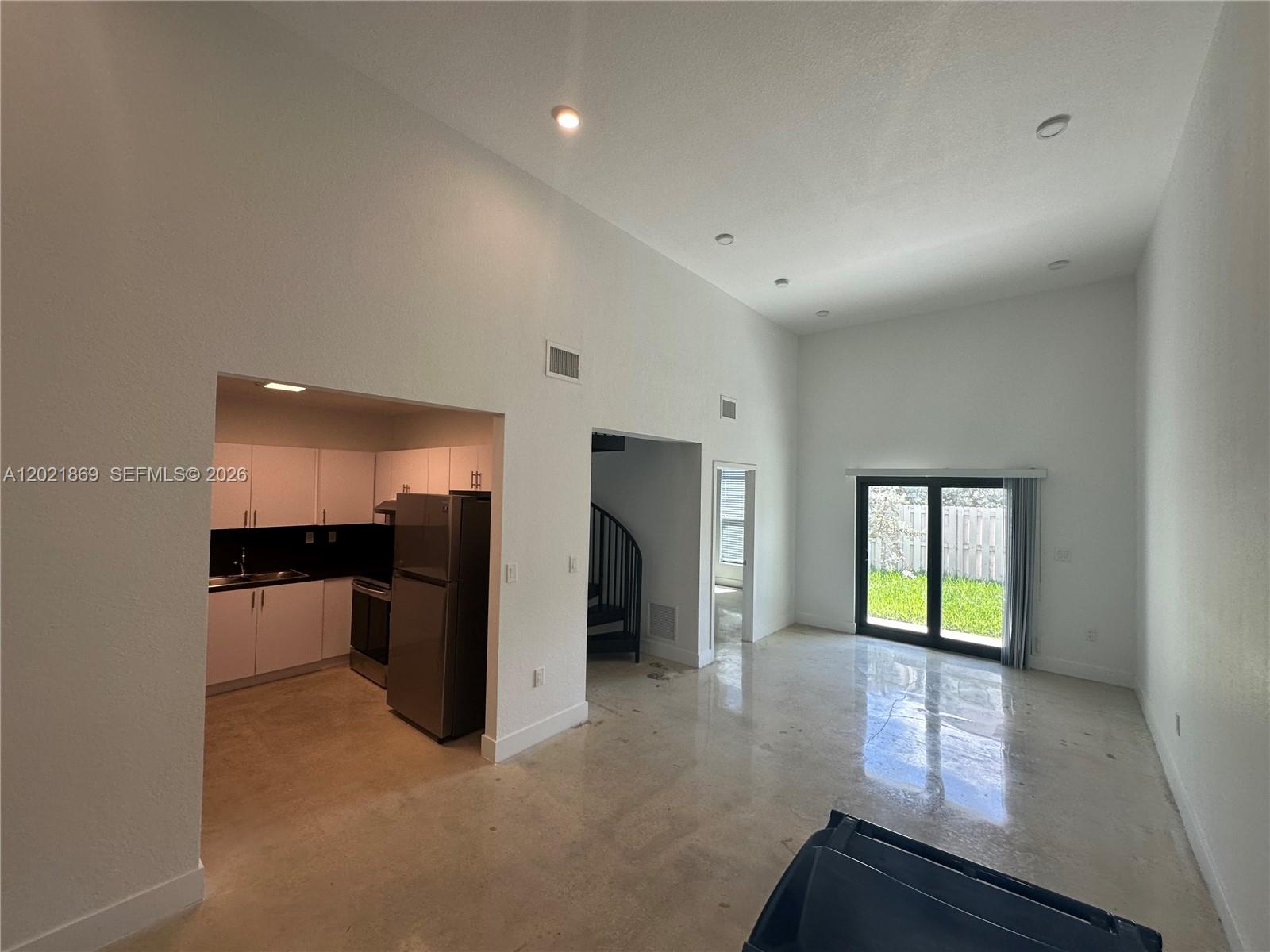 23935 Southwest 110th Court, Unit 23935 Homestead, FL 33032 - Photo 2 of 10 wooden floor in an empty room with a window