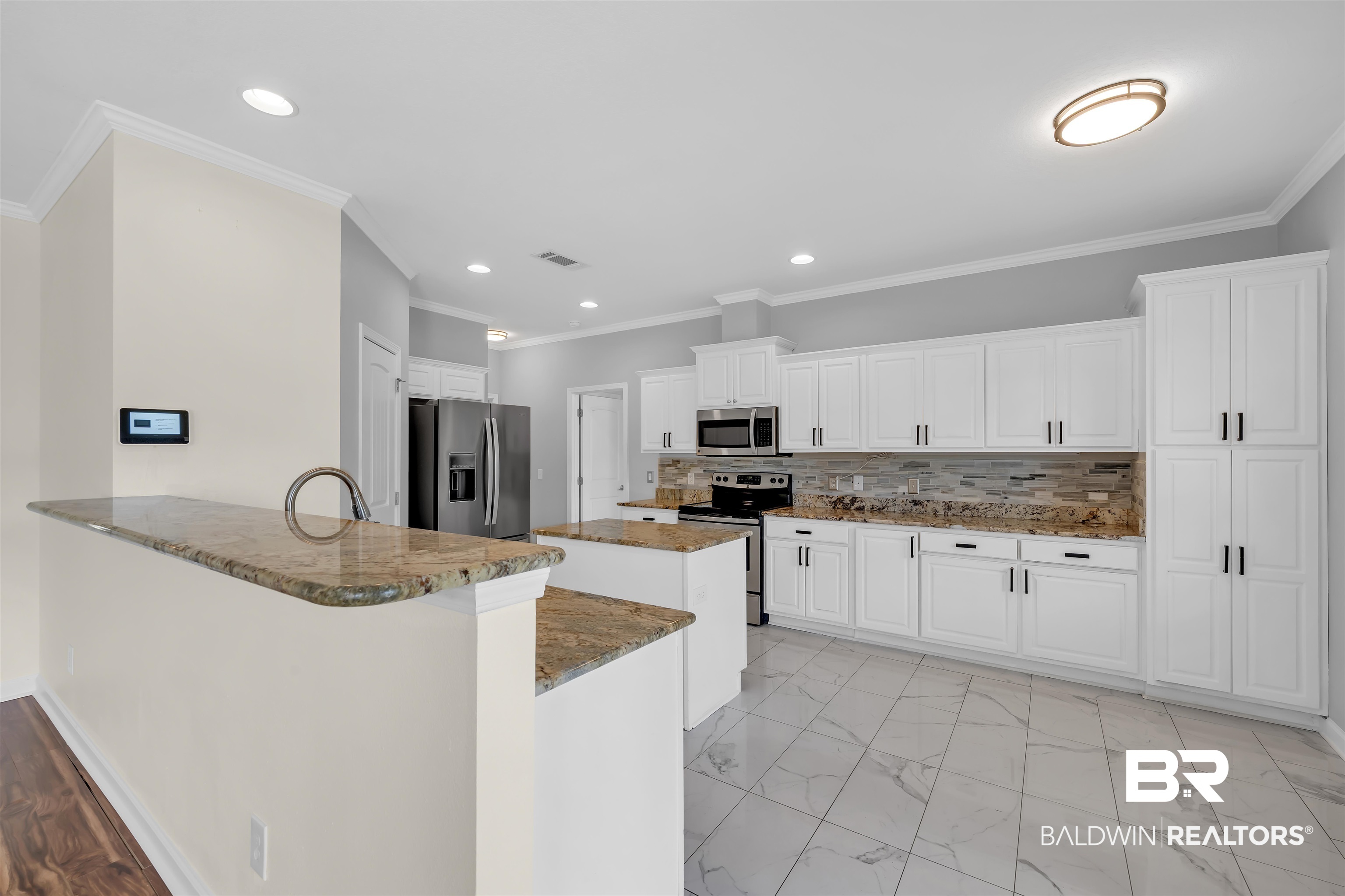 10147 Lyttleton Loop Lillian, AL 36549 - Photo 15 of 29 Kitchen featuring white cabinetry, stainless steel appliances, granite countertops, and tile flooring