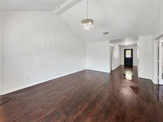a view of a room with wooden floor and window