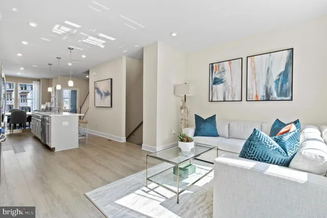 a living room with furniture and kitchen view