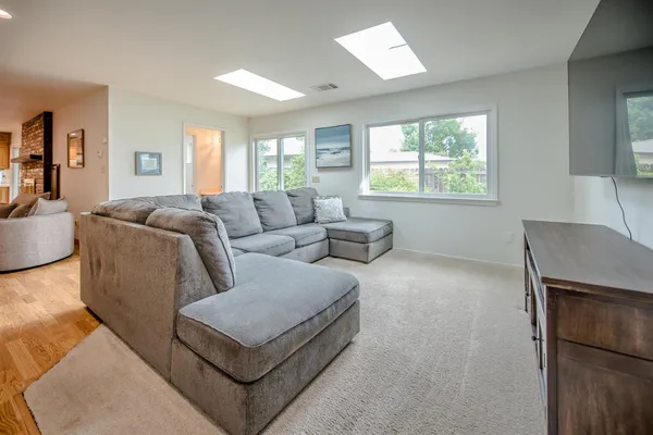a living room with furniture and a wooden floor