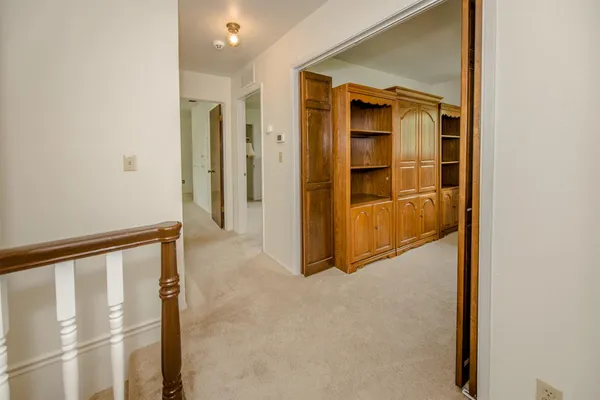 an empty room with windows and ceiling fan