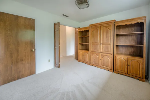 an empty room with a window and a ceiling fan