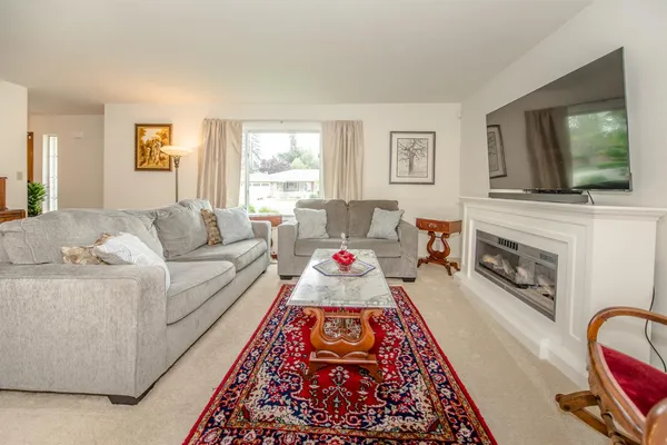 a living room with furniture fireplace and flat screen tv
