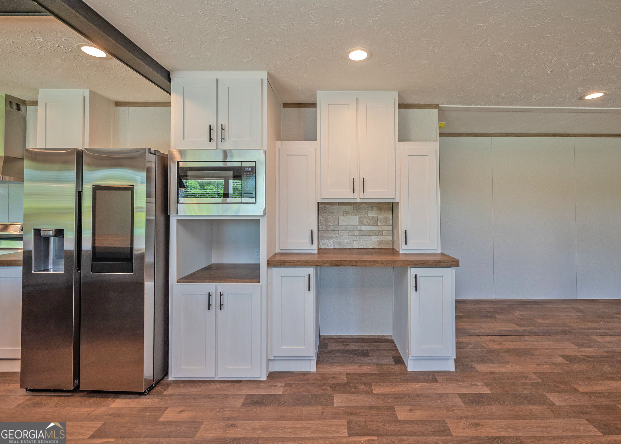 413 Griffin Road Martin, GA 30557 - Photo 9 of 31 a kitchen with white cabinets and stainless steel appliances