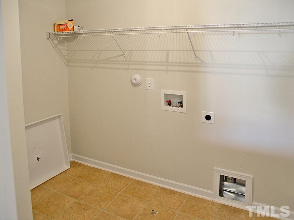4201 Kellett Lane Raleigh, NC 27616 - Photo 16 of 30 The Laundry Rm w/shelving & neutral vinyl floor is off the Loft.