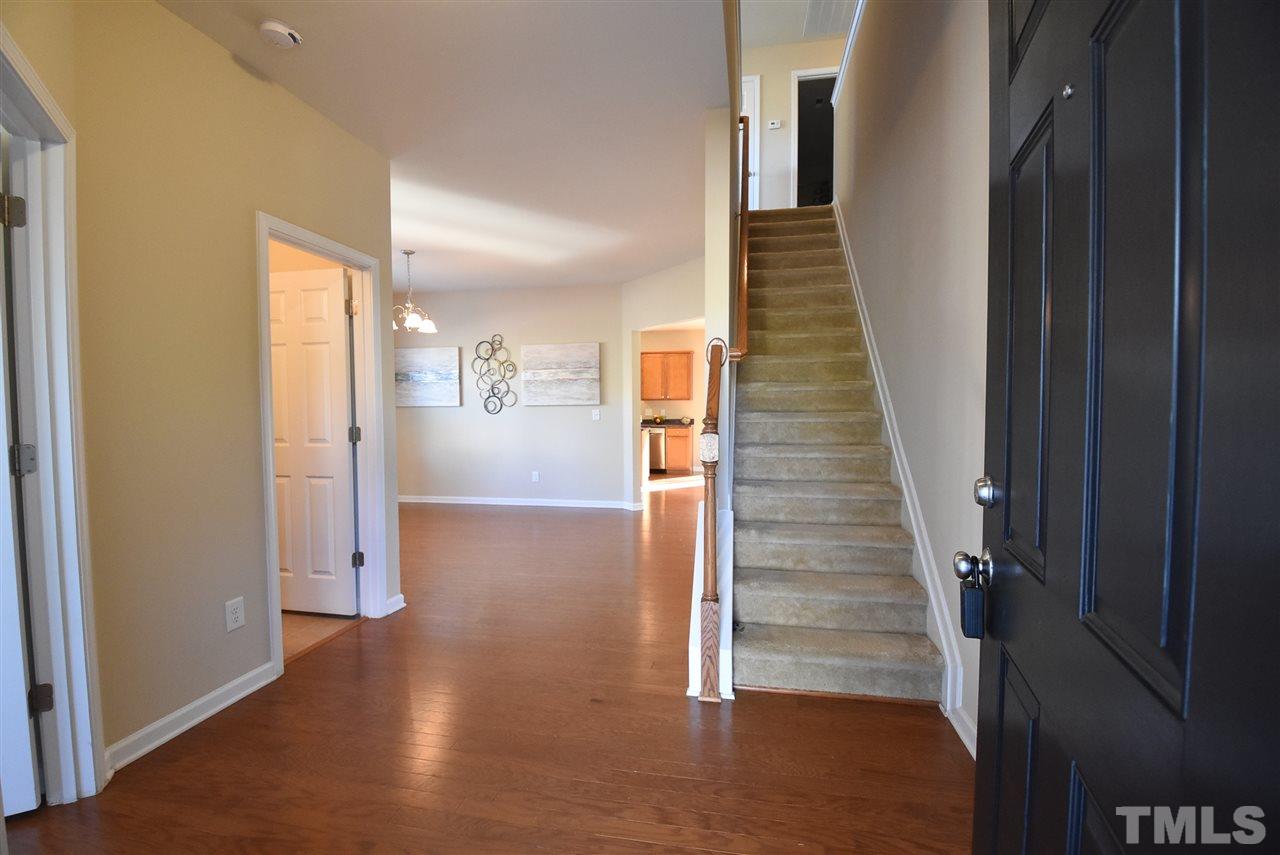 View of the welcoming Foyer. Home features hardwood floors & 9’ smooth ceilings main level, built-in Ethernet & transferrable structural warranty.