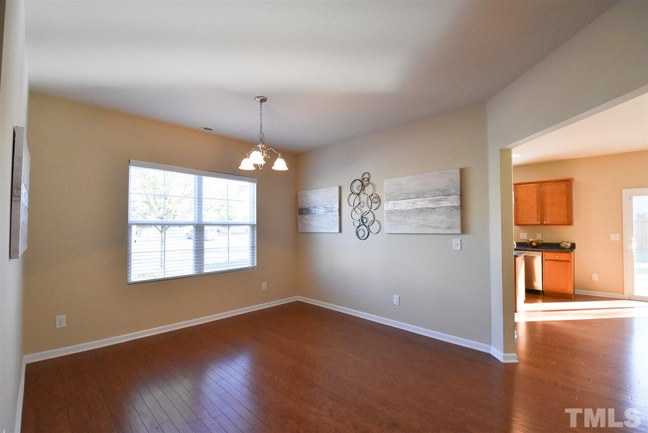 Spacious formal Dining Rm w/brushed nickel light fixture & hardwood floor.