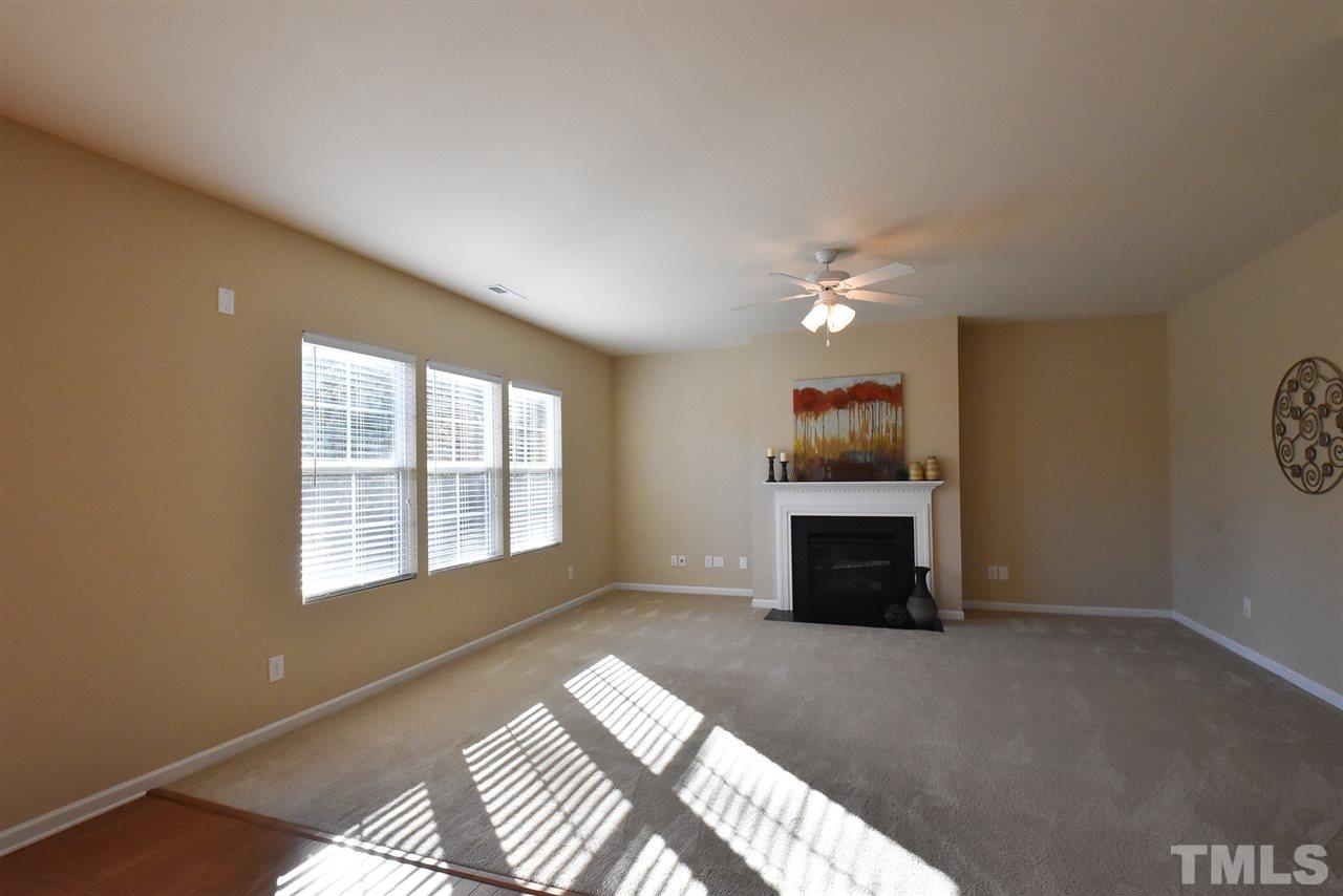 4201 Kellett Lane Raleigh, NC 27616 - Photo 9 of 30 Big Living Rm offers a gas log FP, triple windows, neutral carpet & CF.