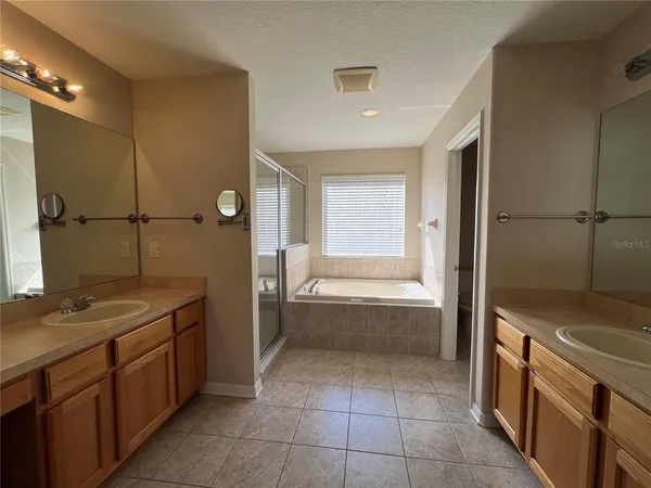 a bathroom with a granite countertop sink a toilet and bathtub