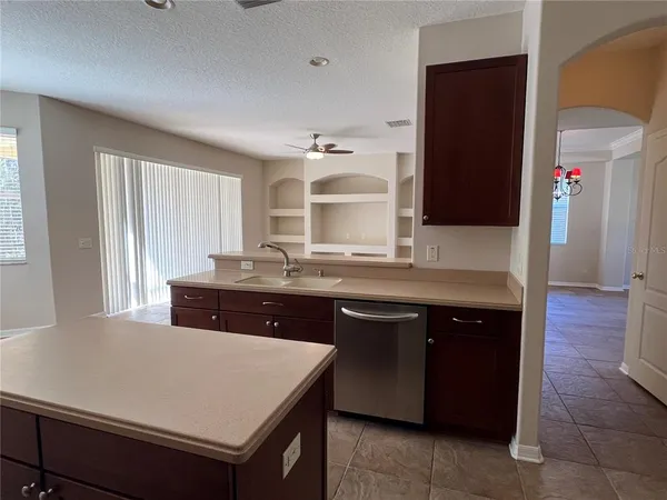 a kitchen with a sink and a refrigerator