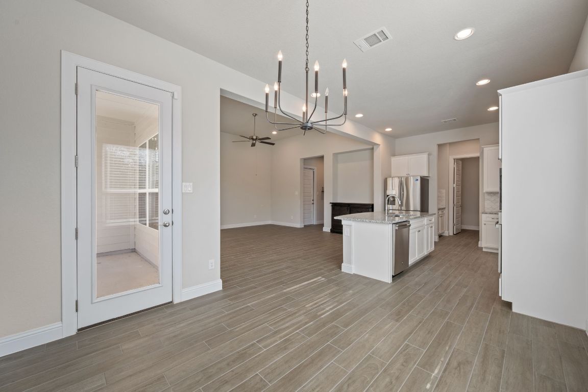 1601 Highland Ridge Road Georgetown, TX 78628 - Photo 36 of 37 a view of a kitchen with refrigerator and a wooden floor