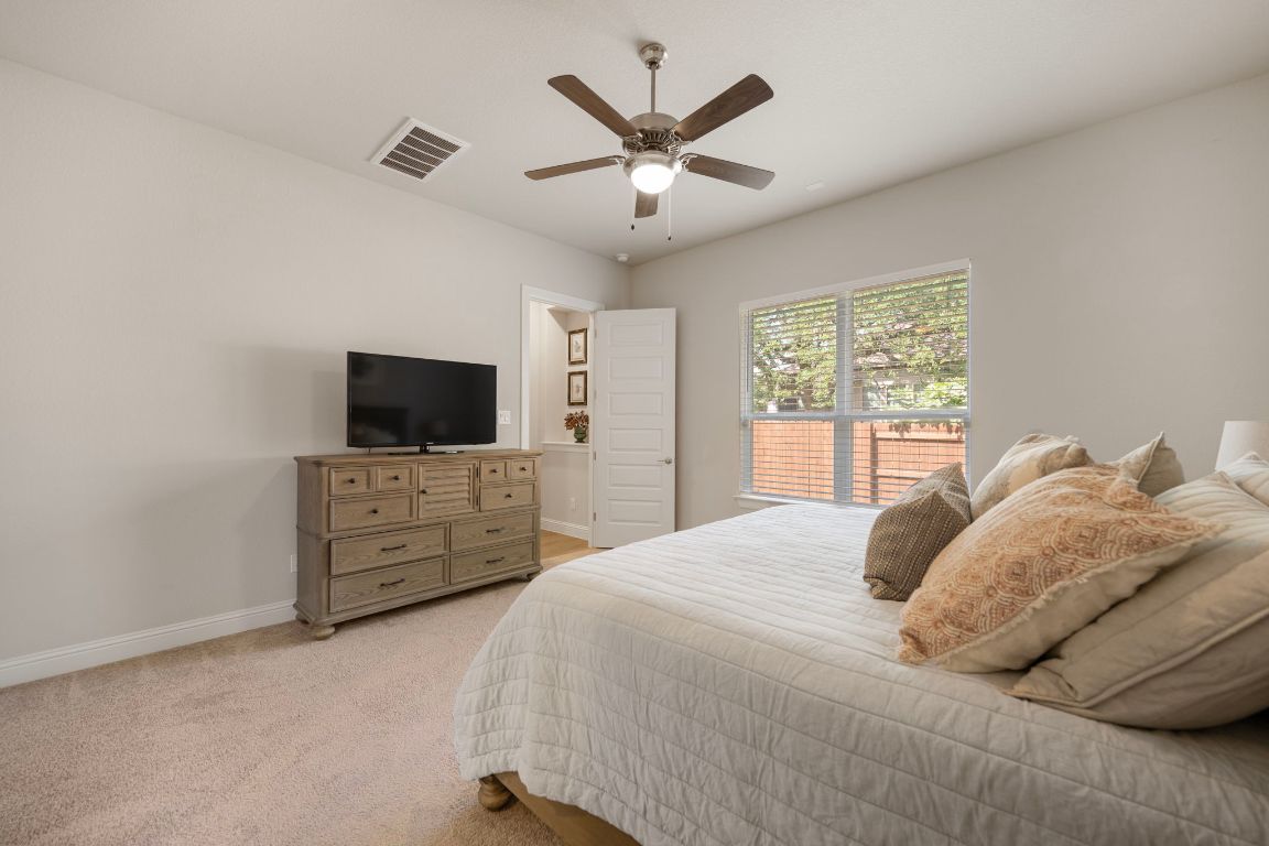 1601 Highland Ridge Road Georgetown, TX 78628 - Photo 15 of 37 a bedroom with a large bed and a flat screen tv