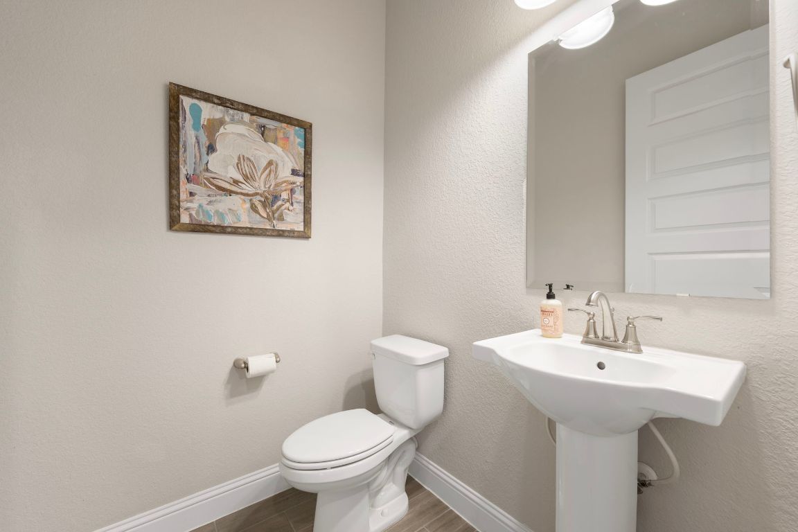 1601 Highland Ridge Road Georgetown, TX 78628 - Photo 18 of 37 a bathroom with a toilet sink and mirror