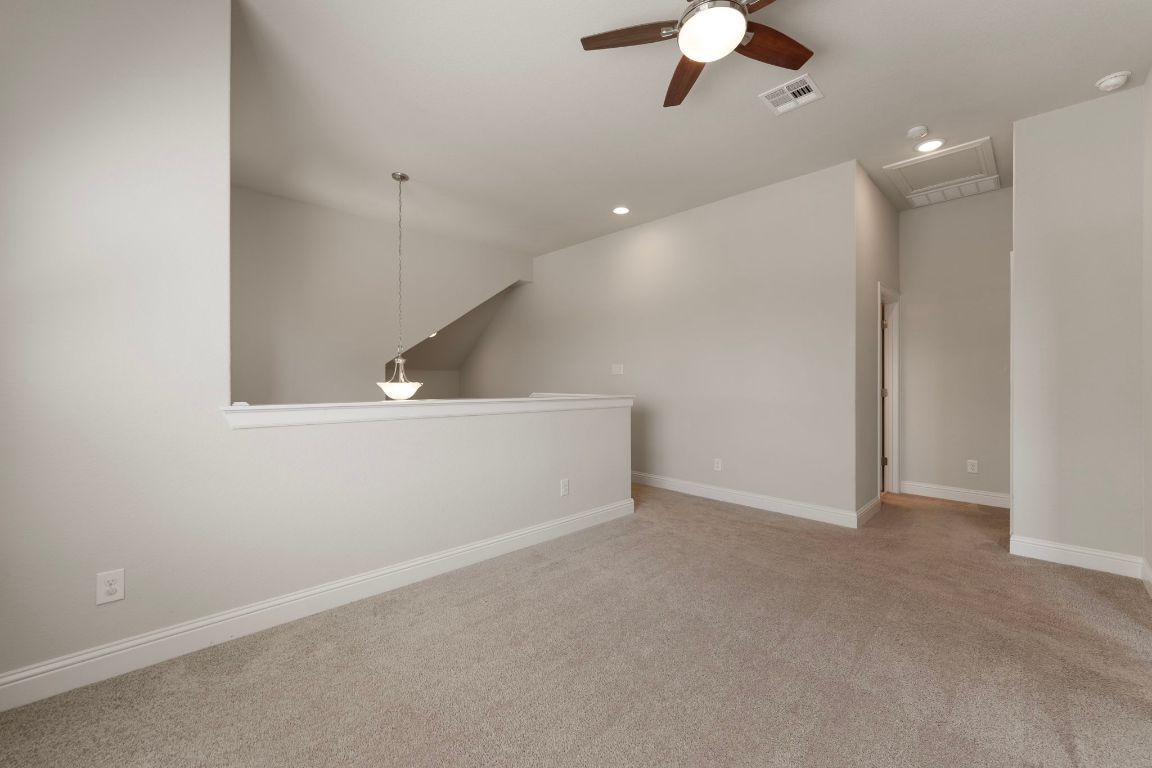 1601 Highland Ridge Road Georgetown, TX 78628 - Photo 24 of 37 wooden floor in an empty room with a ceiling fan