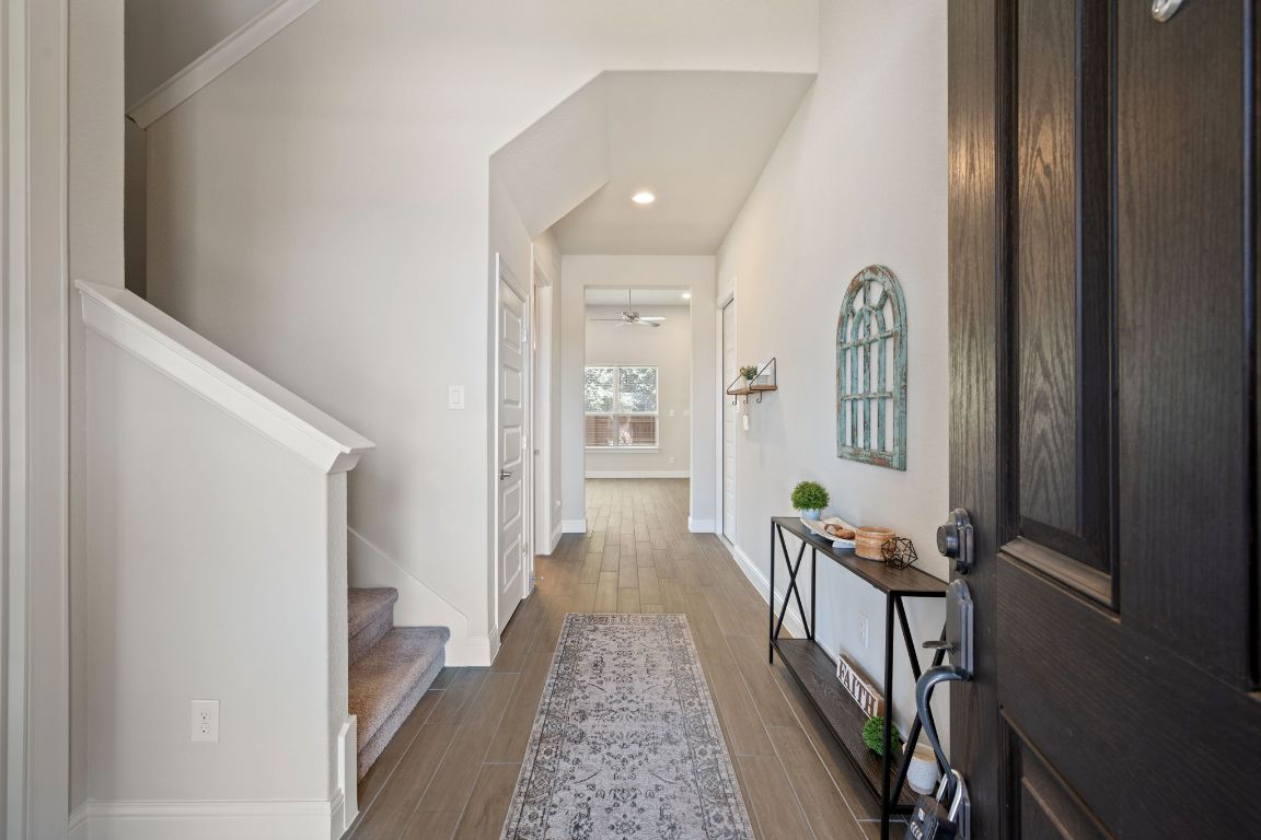 1601 Highland Ridge Road Georgetown, TX 78628 - Photo 3 of 37 a view of a hallway with wooden floor and windows