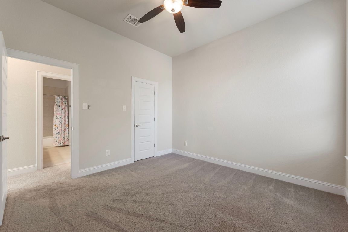 1601 Highland Ridge Road Georgetown, TX 78628 - Photo 30 of 37 an empty room with a ceiling fan and carpet