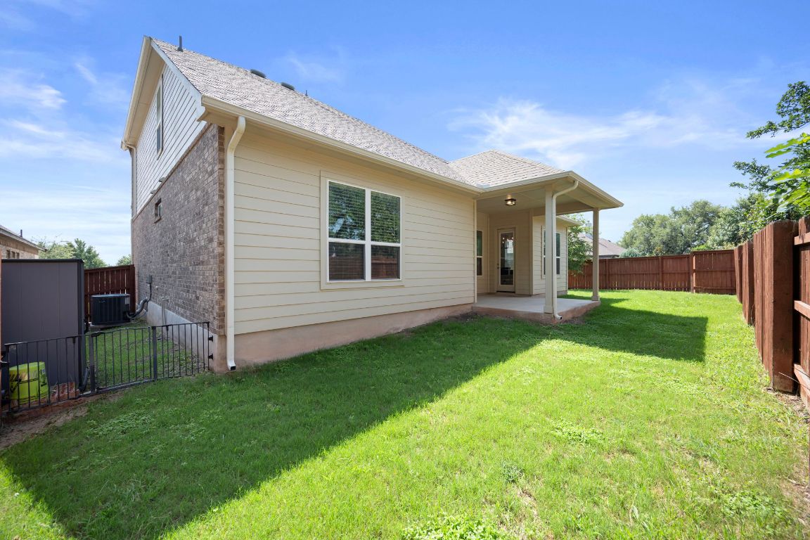 1601 Highland Ridge Road Georgetown, TX 78628 - Photo 33 of 37 a view of a house with backyard and a tree