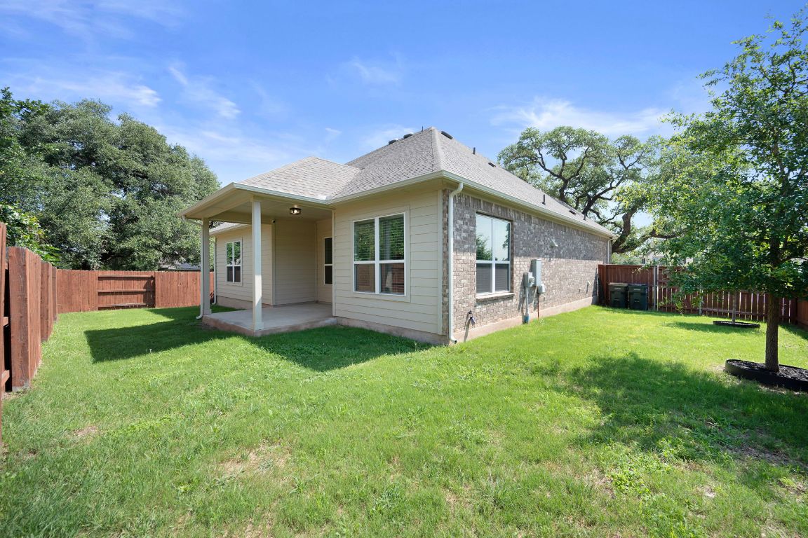 1601 Highland Ridge Road Georgetown, TX 78628 - Photo 34 of 37 a view of a backyard with plants and large tree
