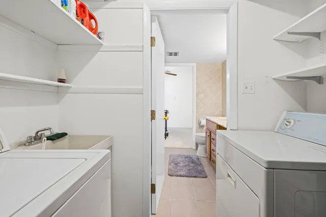a utility room with cabinets washer and dryer