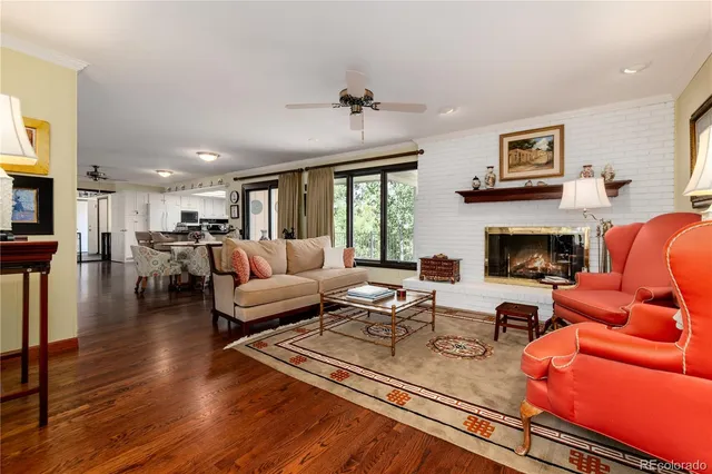 a living room with furniture fireplace and a large window