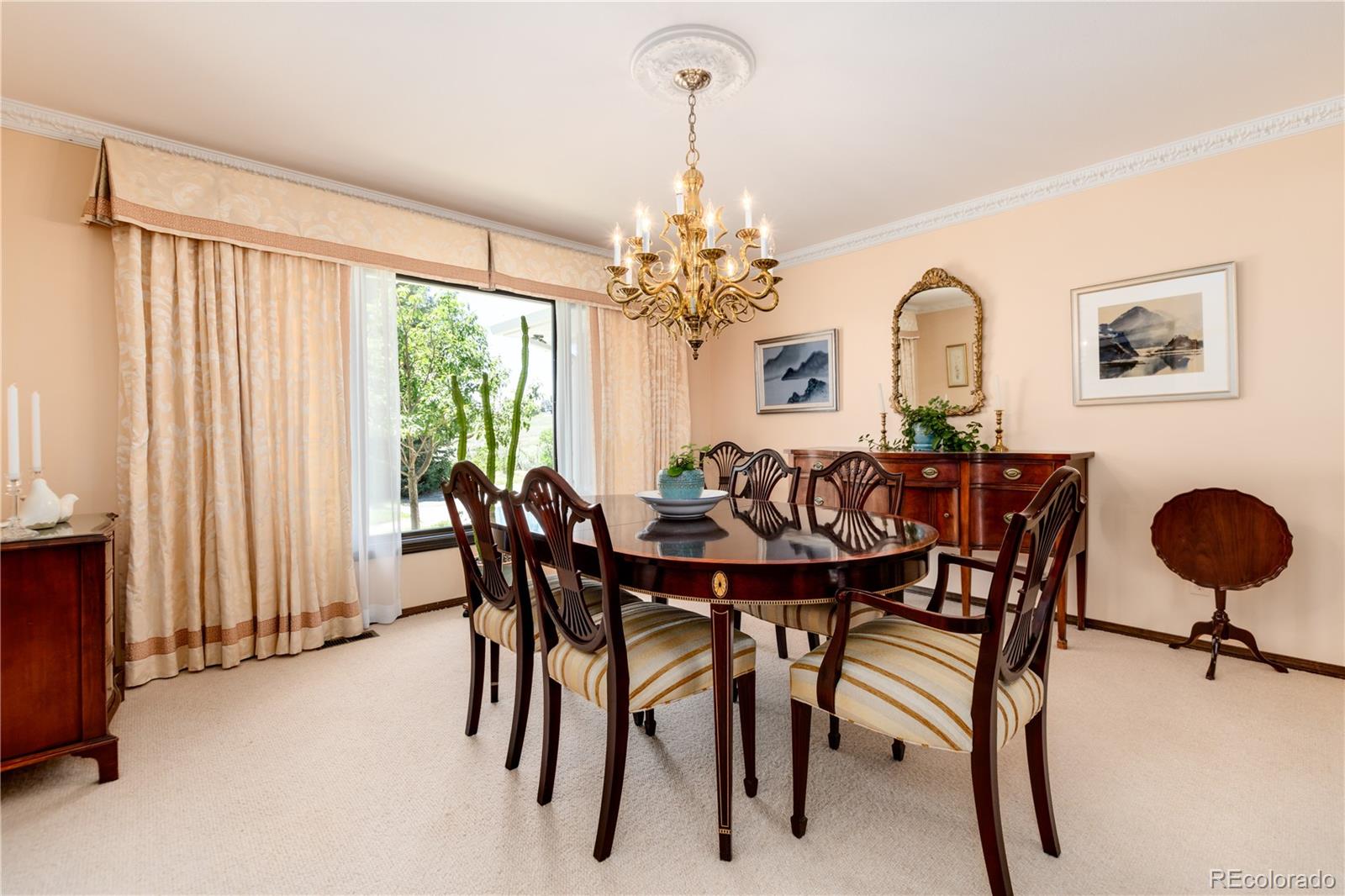 7846 North Village Road Parker, CO 80134 - Photo 19 of 50 a view of a dining room with furniture and a chandelier