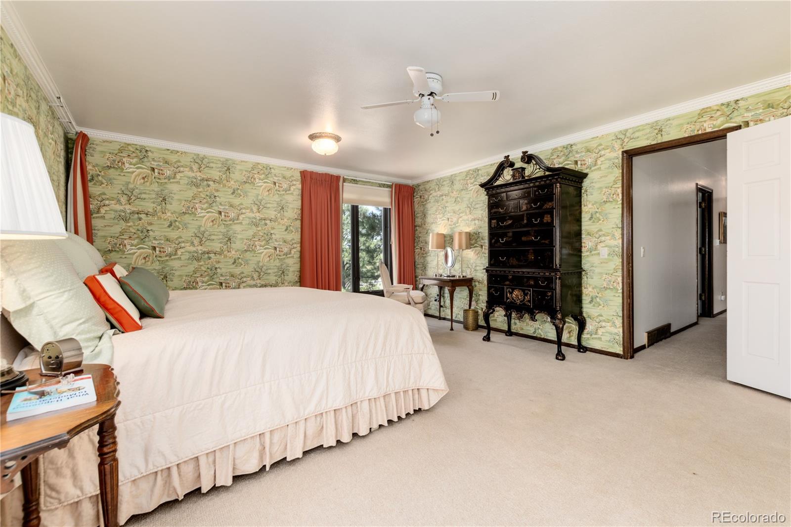 7846 North Village Road Parker, CO 80134 - Photo 23 of 50 a spacious bedroom with a bed a dresser and a large mirror