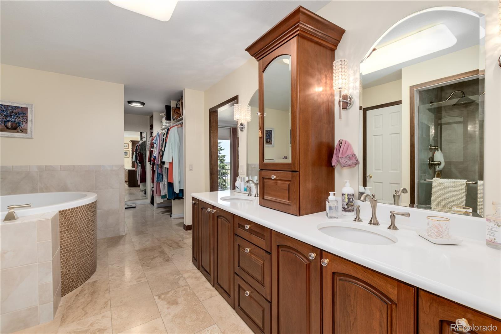 7846 North Village Road Parker, CO 80134 - Photo 25 of 50 a bathroom with a double vanity sink and a mirror