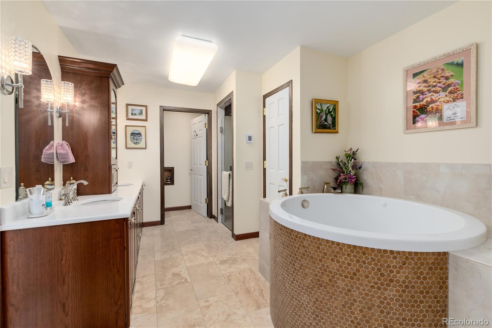 7846 North Village Road Parker, CO 80134 - Photo 26 of 50 a spacious bathroom with a tub sink and mirror