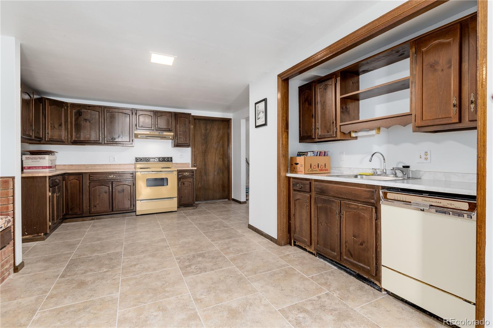 7846 North Village Road Parker, CO 80134 - Photo 34 of 50 a kitchen with stainless steel appliances granite countertop a stove top oven a sink dishwasher and a refrigerator