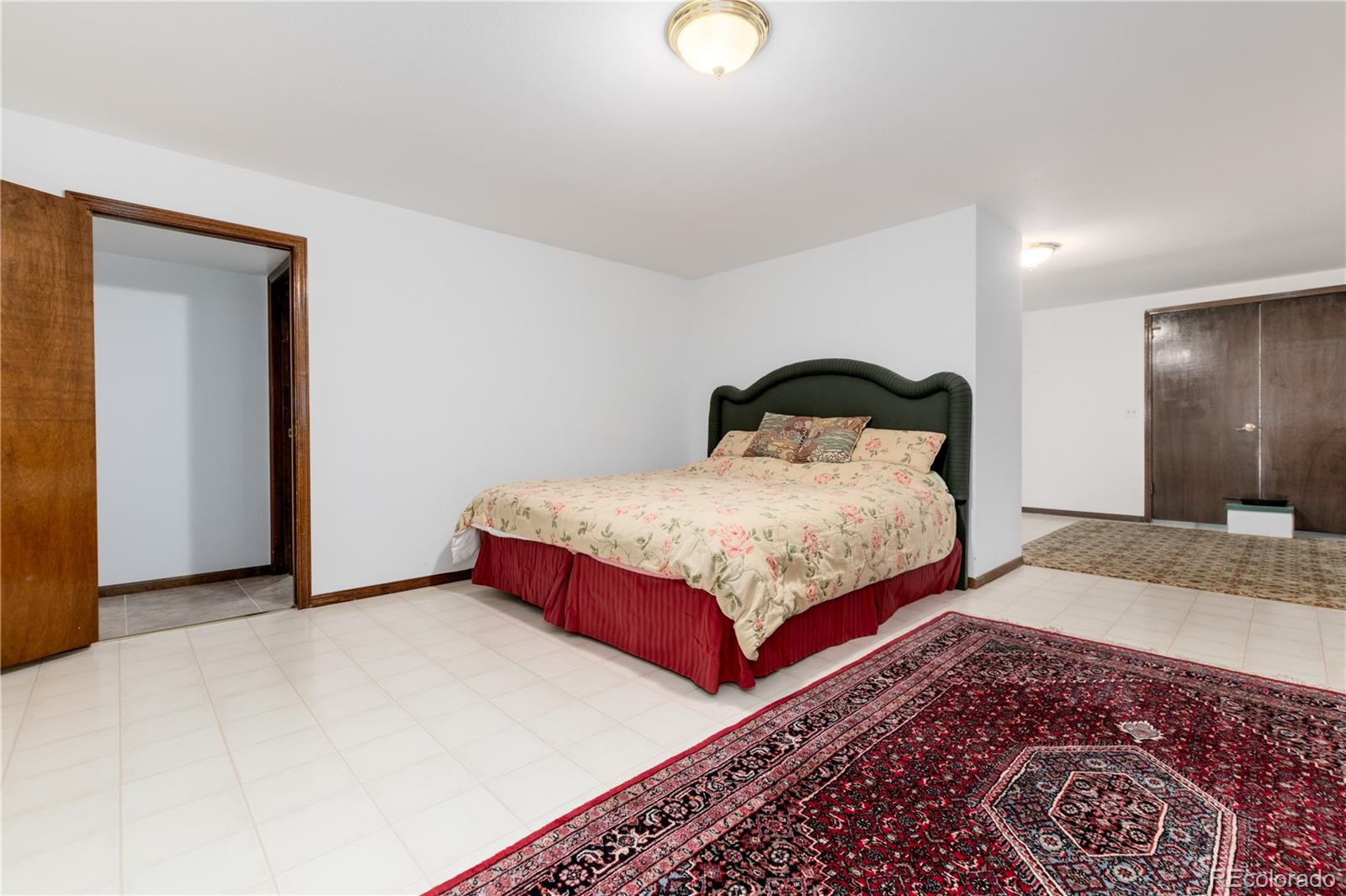 7846 North Village Road Parker, CO 80134 - Photo 36 of 50 a bedroom with a large bed and a dresser