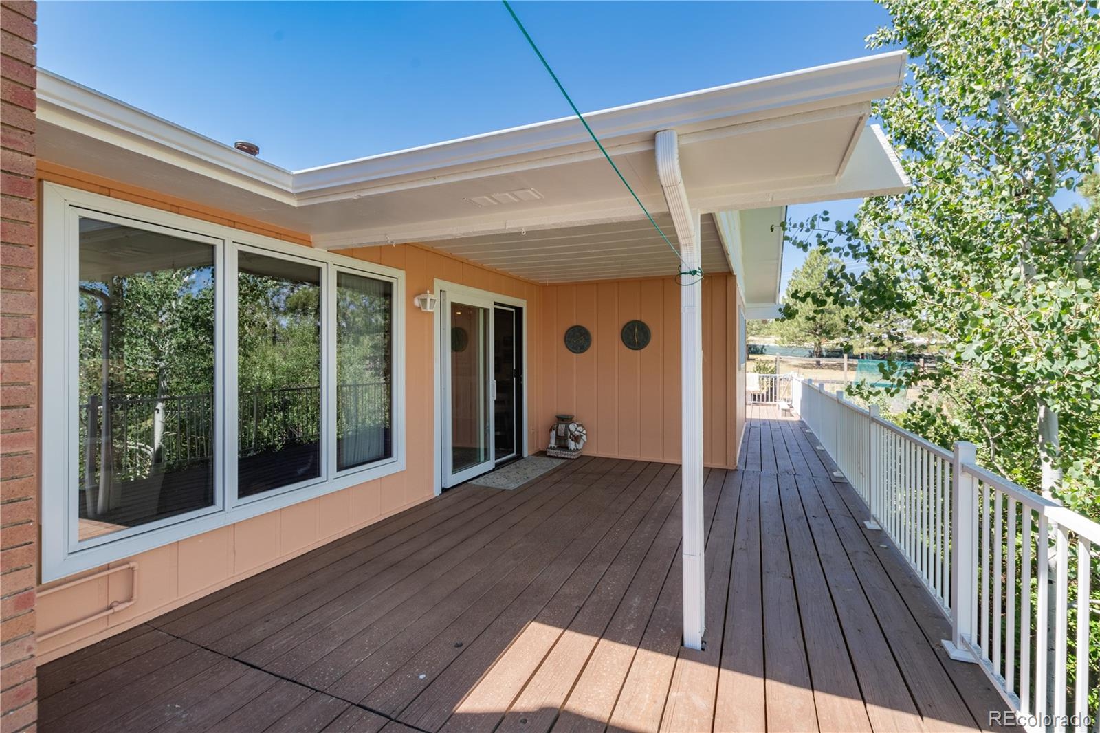 7846 North Village Road Parker, CO 80134 - Photo 39 of 50 a view of a porch with wooden floor and outdoor space