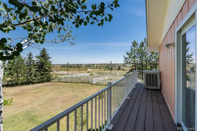 a view of a yard with wooden fence