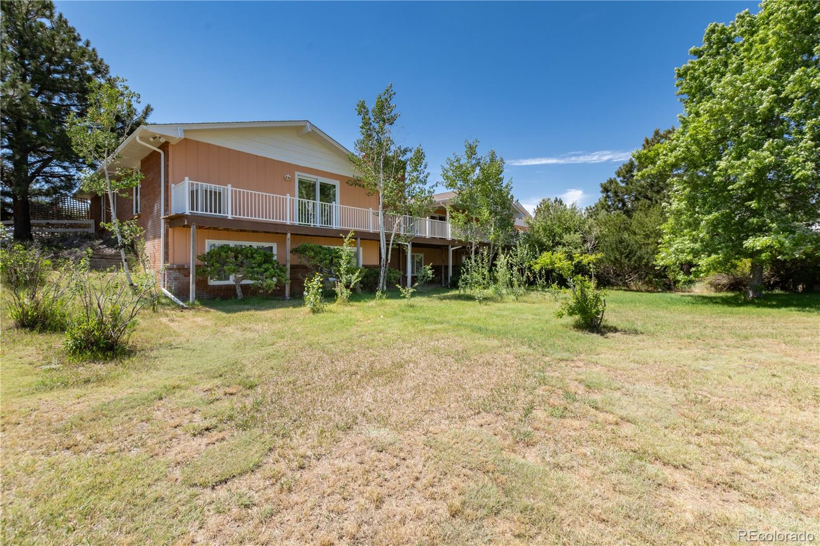 7846 North Village Road Parker, CO 80134 - Photo 43 of 50 a view of a house with a yard
