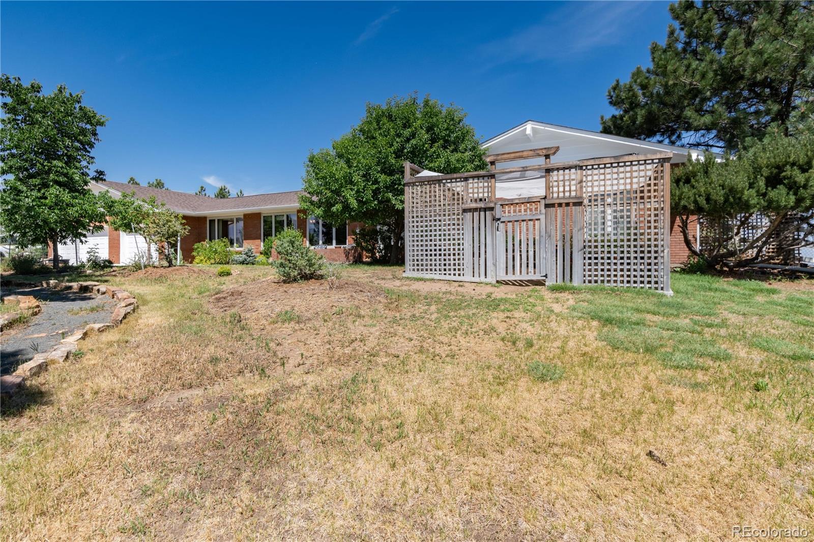 7846 North Village Road Parker, CO 80134 - Photo 49 of 50 a view of a house with a yard and garage