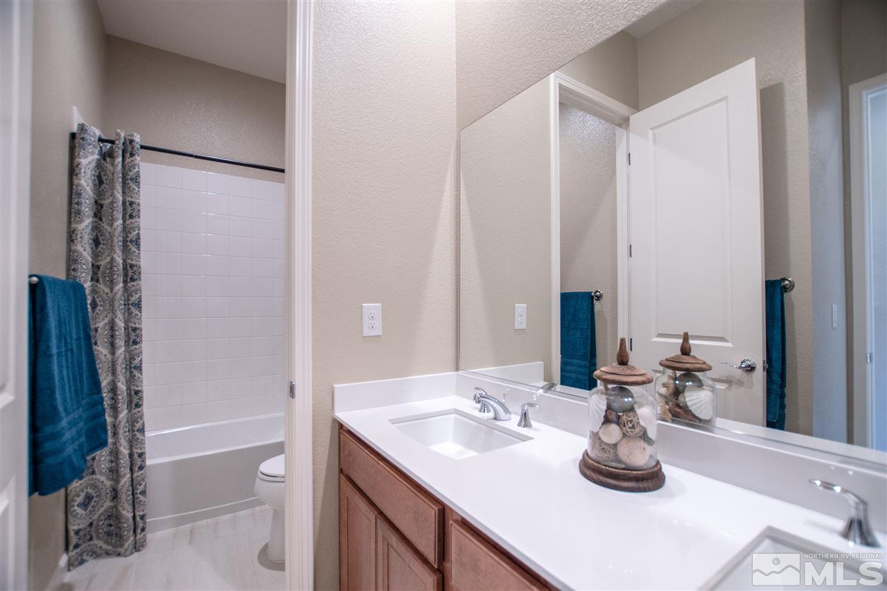 9420 Stony Hill Road, Unit LOT 52 Reno, NV 89521 - Photo 18 of 23 a bathroom with a sink a toilet and shower