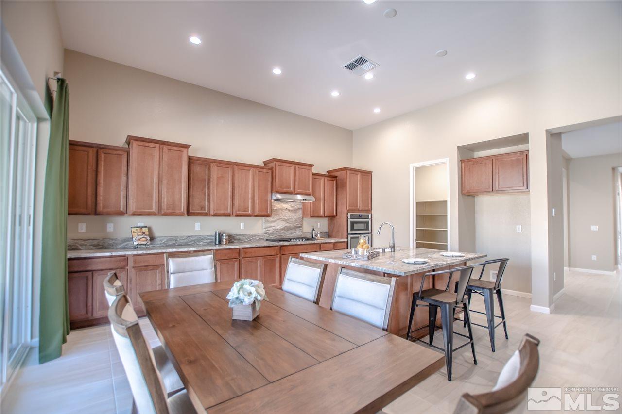 9420 Stony Hill Road, Unit LOT 52 Reno, NV 89521 - Photo 6 of 23 a kitchen with a table chairs and microwave