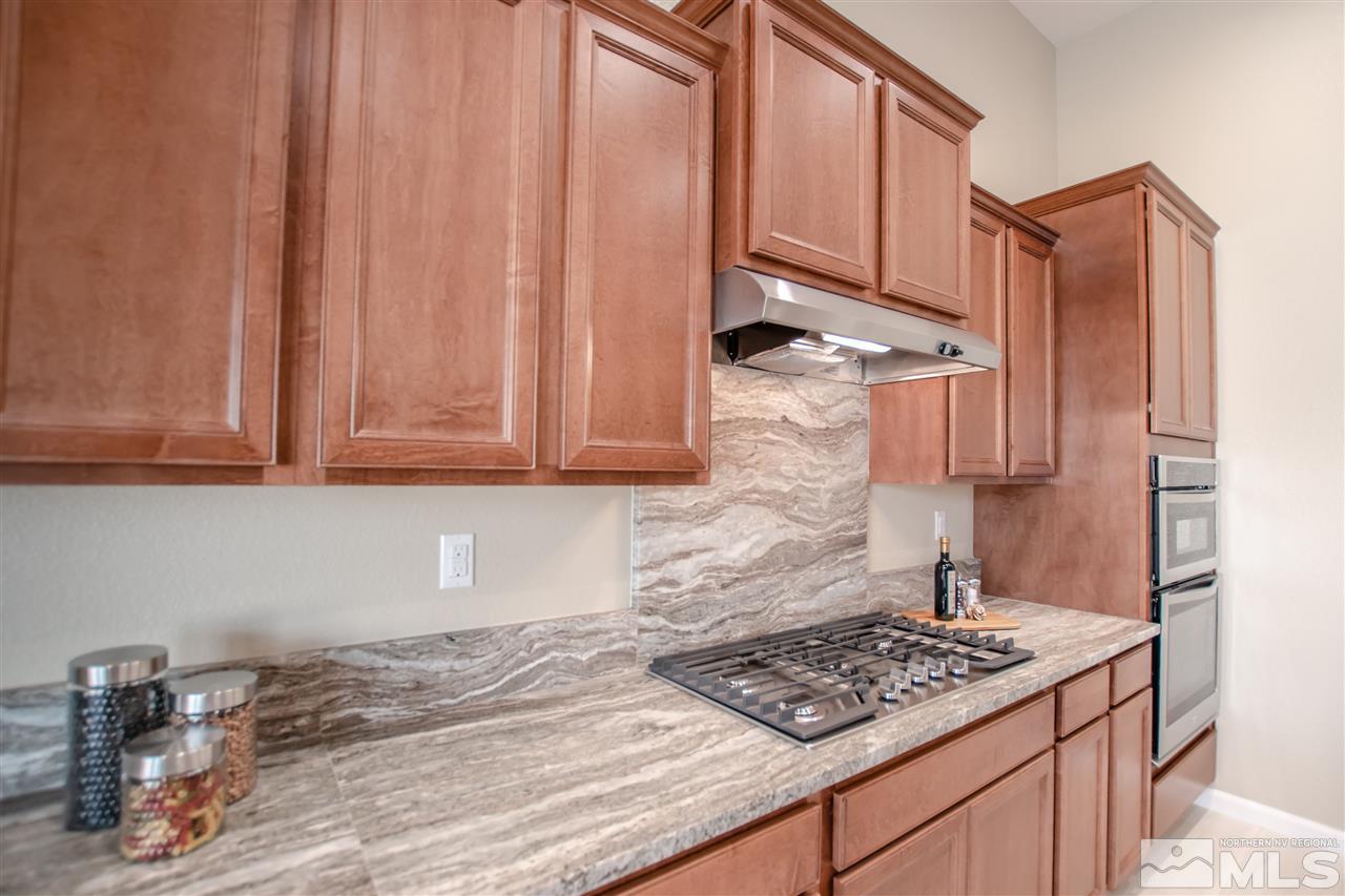 9420 Stony Hill Road, Unit LOT 52 Reno, NV 89521 - Photo 8 of 23 a kitchen with stainless steel appliances granite countertop a refrigerator stove and sink