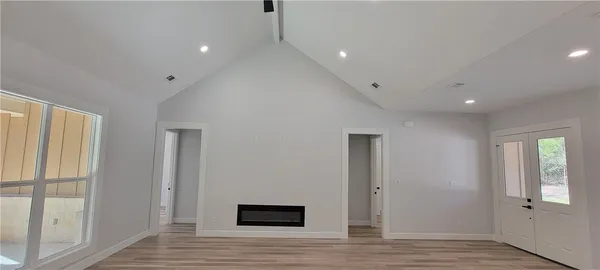 a view of a hallway with wooden floor
