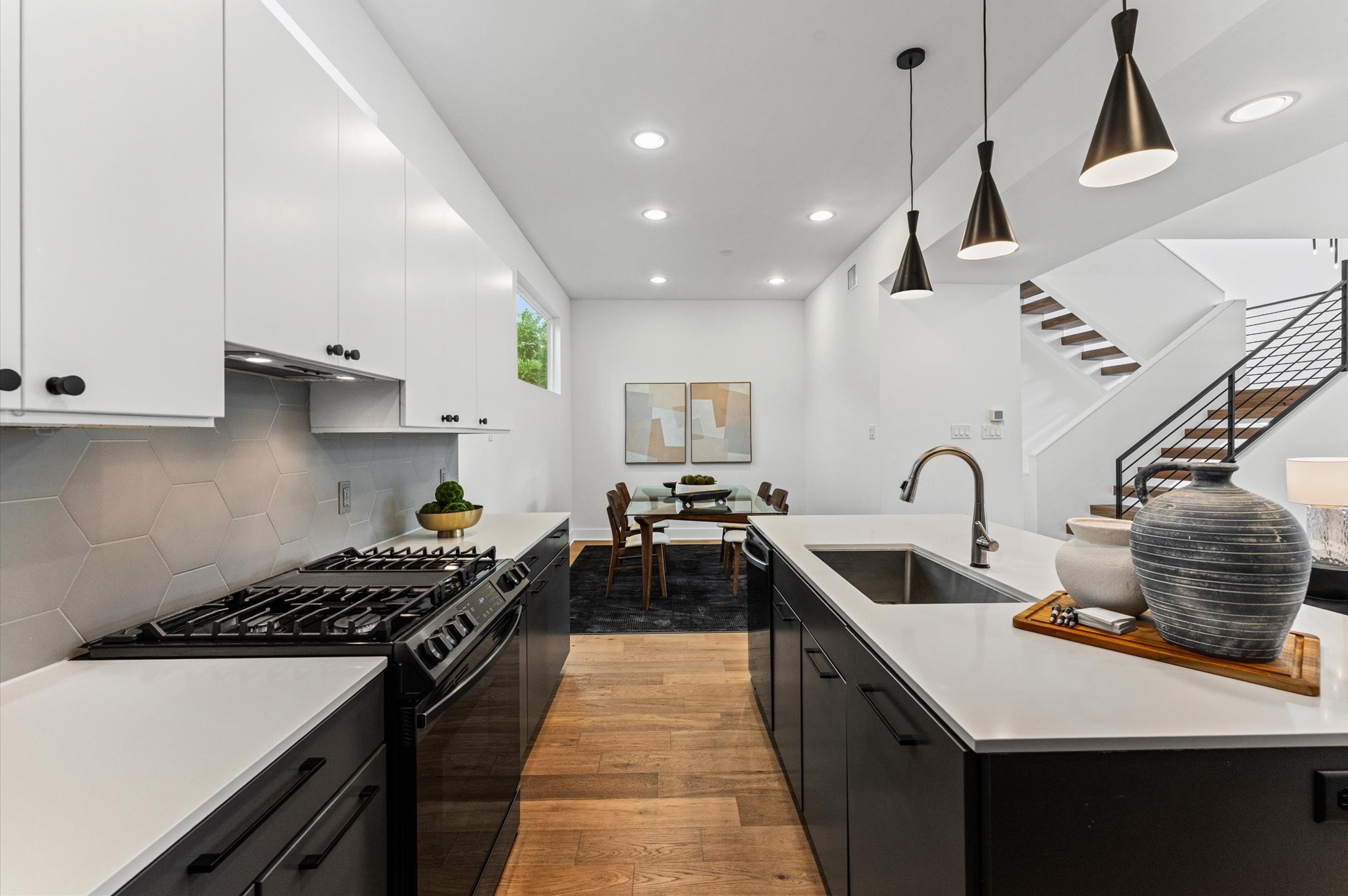 1404 Bailey Street Houston, TX 77019 - Photo 11 of 25 a kitchen with stainless steel appliances granite countertop a sink stove and refrigerator