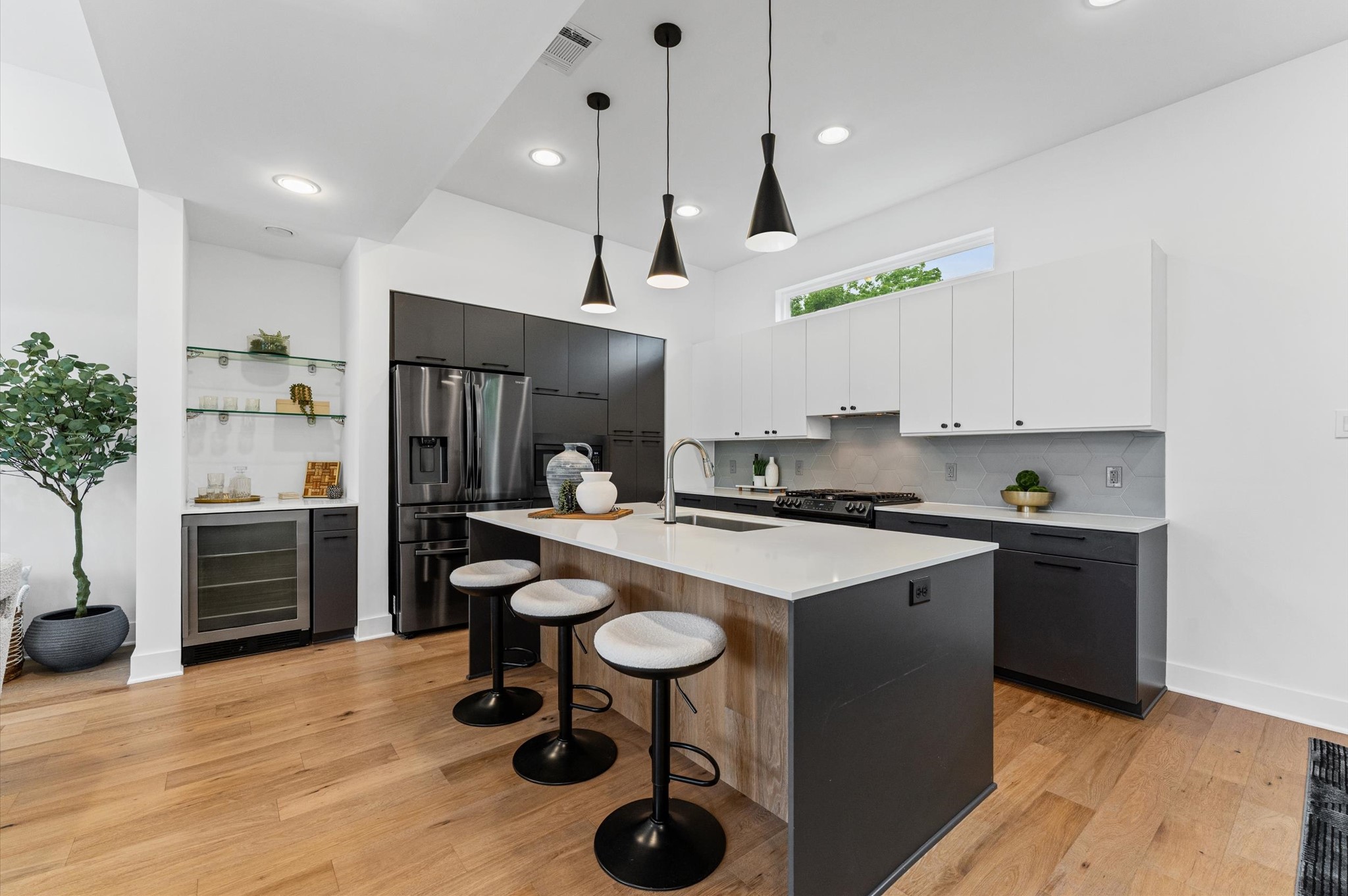 1404 Bailey Street Houston, TX 77019 - Photo 13 of 25 a kitchen with kitchen island stainless steel appliances a stove a refrigerator a sink cabinets and wooden floor