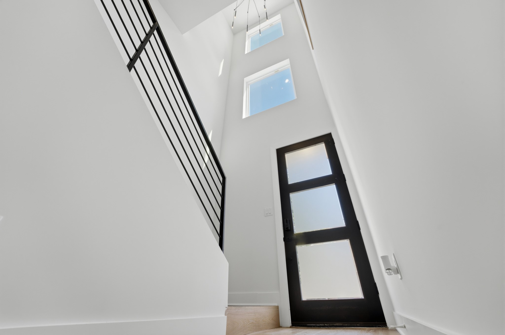 1404 Bailey Street Houston, TX 77019 - Photo 4 of 25 a view of staircase with wooden floor and white walls