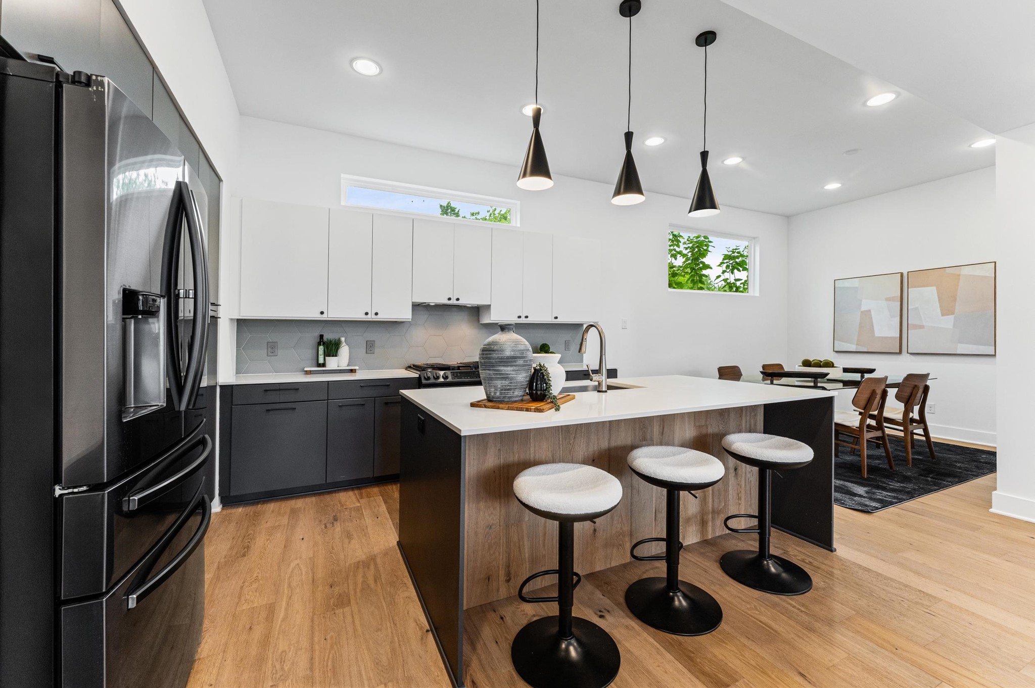 1404 Bailey Street Houston, TX 77019 - Photo 10 of 25 a kitchen with stainless steel appliances granite countertop a sink a stove a refrigerator cabinets and chairs