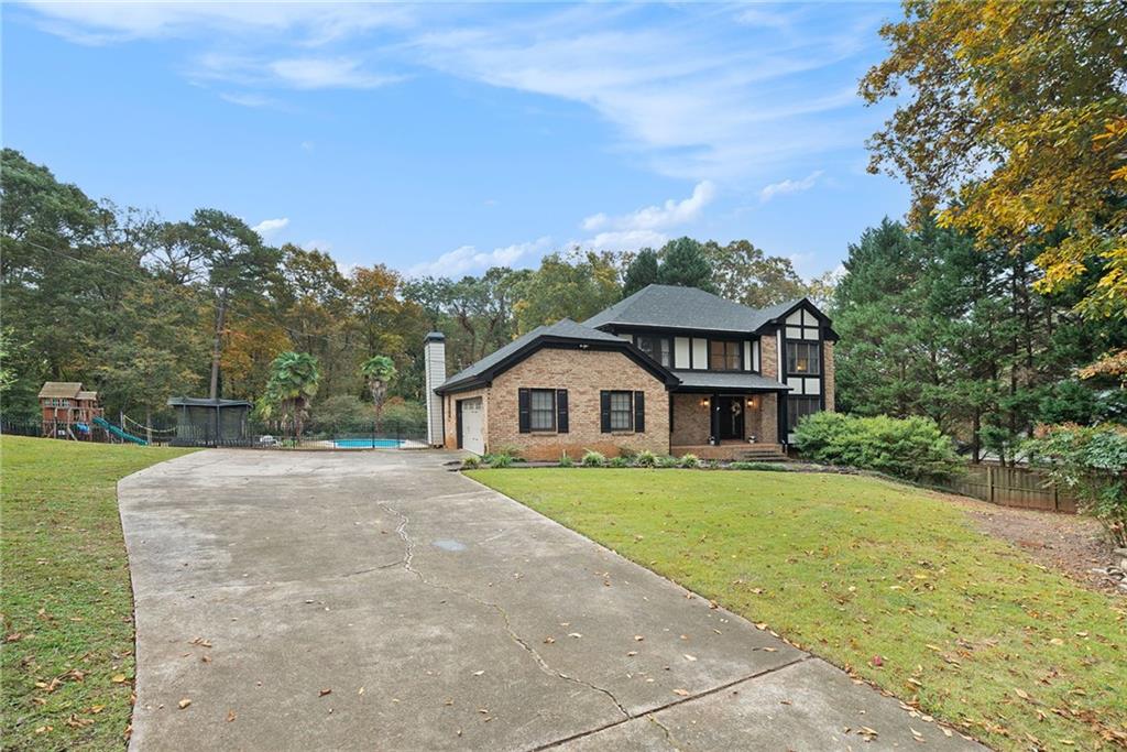1991 Lilburn-Stone Mountain Road Stone Mountain, GA 30087 - Photo 1 of 1 a view of a house with a yard