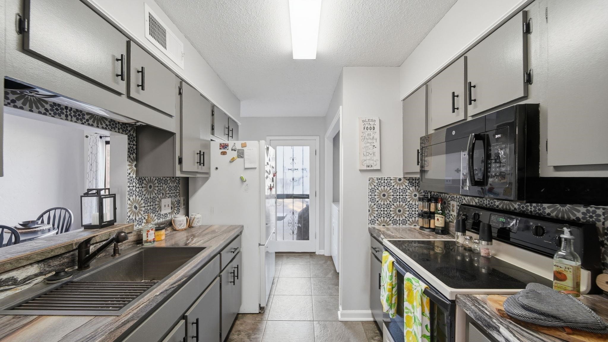 4182 Luther Road Memphis, TN 38135 - Photo 15 of 40 a kitchen with stainless steel appliances granite countertop a sink stove and cabinets