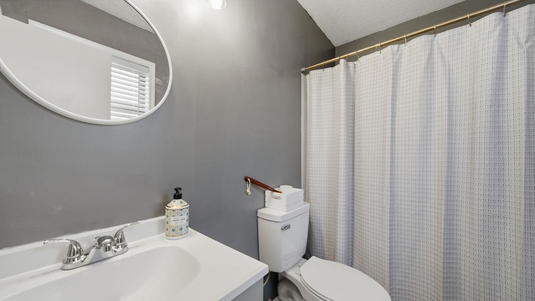 4182 Luther Road Memphis, TN 38135 - Photo 26 of 40 a bathroom with a sink a toilet and a mirror