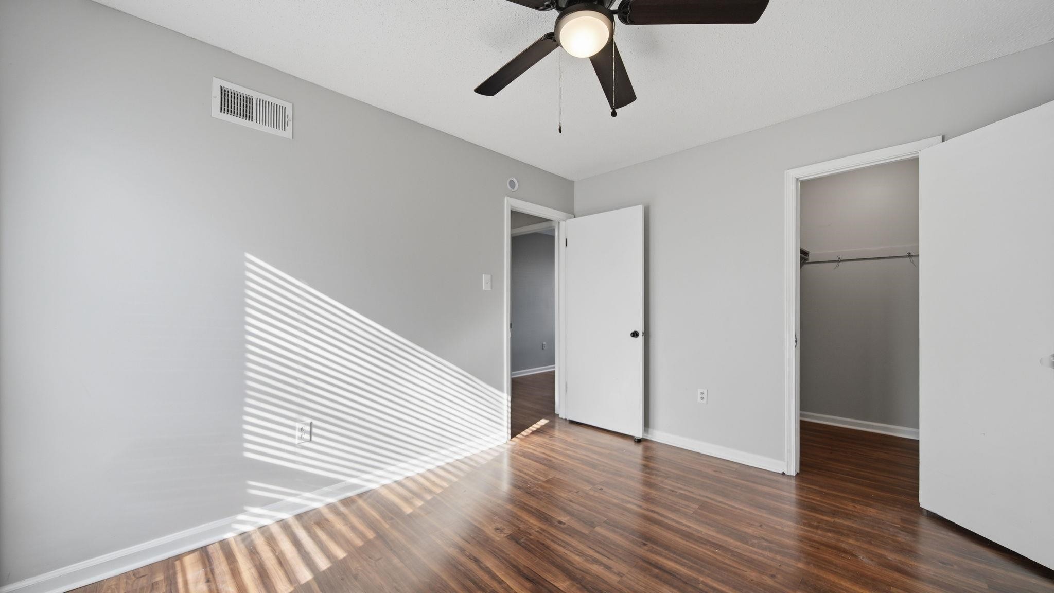 4182 Luther Road Memphis, TN 38135 - Photo 28 of 40 a view of a hallway with wooden floor and a ceiling fan