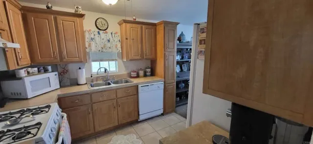 a kitchen with stainless steel appliances granite countertop a sink counter space cabinets and a large window