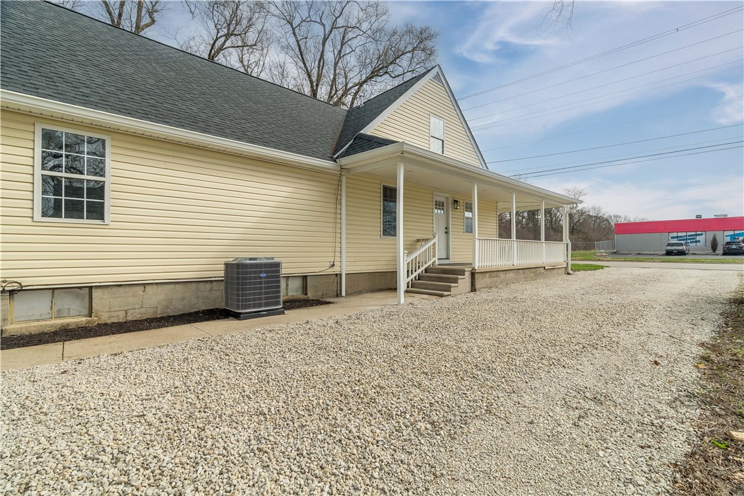 8240 Looney Road Piqua, OH 45356 - Photo 44 of 49 This charming home features a covered porch, offering a welcoming entrance and ample outdoor living space.