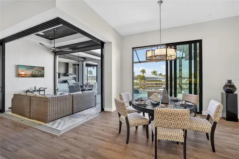 a view of a dining room with furniture a chandelier and wooden floor